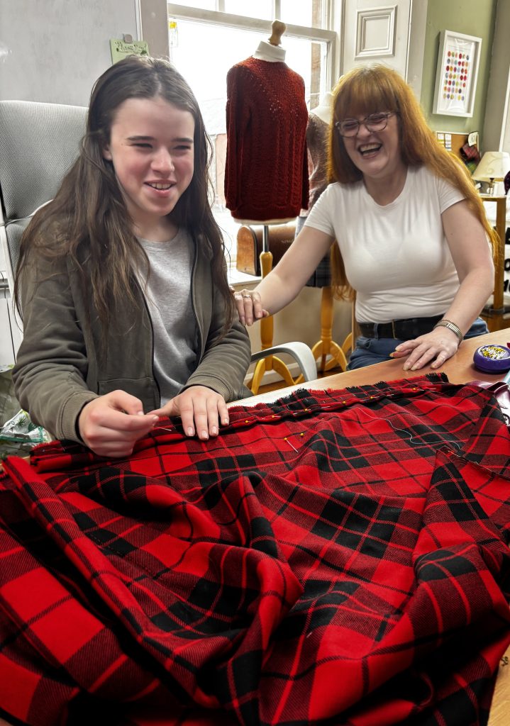 Student learning to make a kilt